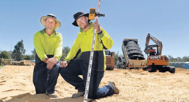 Under construction: Greater Shepparton City Council parks, sport and recreation team members Paul Parsons and Louis Worm at the beach volleyball courts being built at Victoria Park Lake.